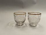 two glasses that are sitting on a table