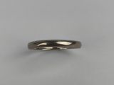 a close up of a wedding ring on a white surface