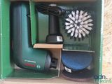 a green box with a brush and other items in it