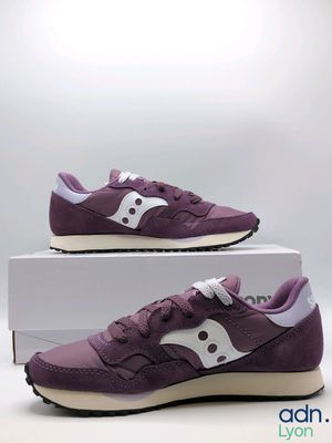 purple saucy sneakers with white soles on a white box