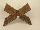 an old wooden box with a dice in it on a white surface