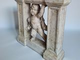 marble statue of a boy holding a teddy bear in a doorway