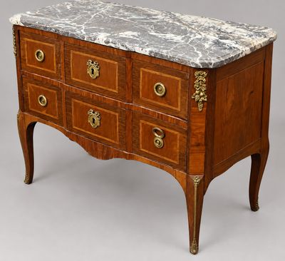an antique chest of drawers with marble top and brass handles