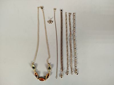 a lot of necklaces that are laying on a table