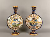 two blue and white vases with gold designs on them