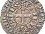 une vieille pièce d'argent ornée d'une croix