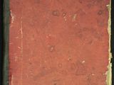 un vieux livre à la couverture rouge posé sur une table