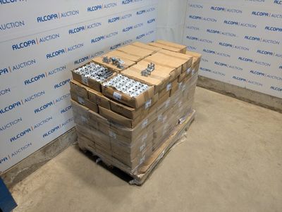 a stack of boxes sitting on top of a pallet in front of a wall