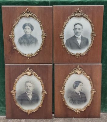 four framed portraits of men and women are on display in a wooden frame