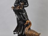 statue of a woman with a goose and a bird on a pedestal