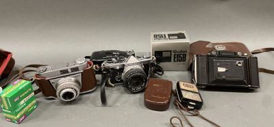 many different types of cameras on the table
