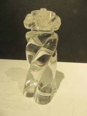 a glass vase with a flower on it on a table