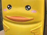 une valise jaune sur laquelle est représenté un canard jaune