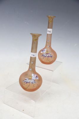three vases that are sitting on a clear stand