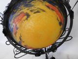 a ball that is sitting on a stand on a table