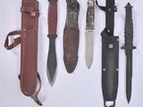 several different types of knives are lined up on a white surface