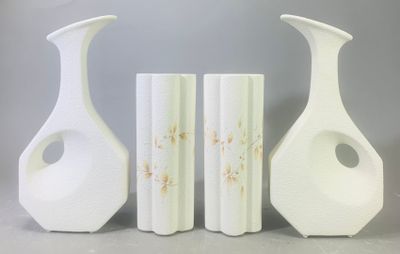 trois vases posés l'un à côté de l'autre sur une table
