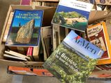 books in a cardboard box on the floor of a room