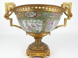 a gold vase with a floral design on it