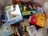many children ' s books in a box on the bed