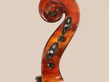 a violin with a long neck and a long tail