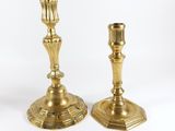 pair of antique brass candlesticks on a white background