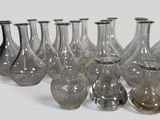 a lot of glass vases that are lined up together