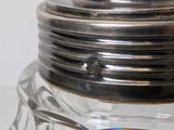 a glass salt and pepper shaker with a silver lid