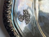 a silver plate with a design on it on a table