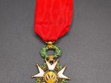 a red ribbon with a gold star on top of it