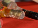 a bottle of alcohol and a bottle of wine on a table