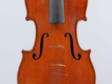 an old violin with a bow hanging from it ' s back