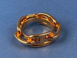 a close up of a gold ring on a blue surface