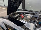 an image of a classic car with its hood open