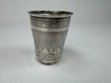 a silver cup that is sitting on a table