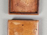 two small wooden boxes are sitting on top of a table