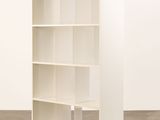 an image of a white bookcase in an empty room