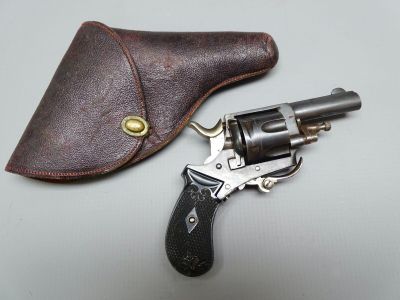 revolver with leather case on table next to leather holster