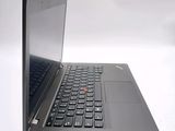 a black laptop with a red button on the keyboard