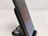 a cell phone that is sitting on top of a stand