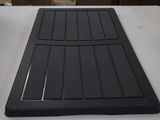 a black mat on a table with a knife and fork