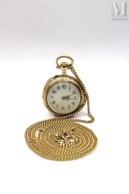 a small gold pocket watch with a chain around it