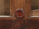 a close up of a wooden door with a red knob