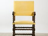 a yellow chair with a wooden frame and a yellow seat