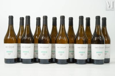 six bottles of wine are lined up in a row on a white surface
