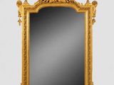 un miroir à cadre doré orné d'un motif représentant un oiseau et une fleur