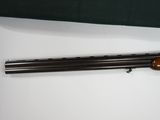 a shotgun with a wooden barrel and a green bag