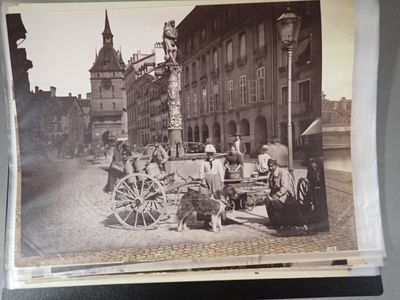 an old photo of a horse drawn carriage on a city street