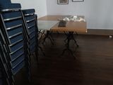 a table and chairs in a room with pictures on the wall