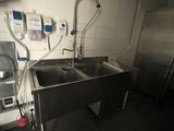 a kitchen with a sink and a stove in it